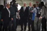  ?? WASHINGTON POST PHOTO BY BILL O’LEARY ?? Supreme Court nominee Neil Gorsuch, center, walks through group of reporters on his way to visit Sen. Susan Collins, R-Maine, on Thursday.