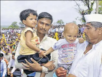  ?? HT PHOTO ?? Slain jawan Sandip Jadhav's father (in white) and two children attend his funeral at Kelgaon village in Aurangabad on Saturday. Jadhav, who was among the two soldiers killed in a crossborde­r ambush, was cremated on his son’s first birthday.