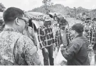  ??  ?? GOV. Edwin Jubahib, right, hands out goodies to Tribal Chieftain Datu Bansing Balanban as a gesture of goodwill during his visit on Friday to the isolated Sitio Tapayanon in Brgy. Gupitan, Kapalong, Davao del Norte. To the back of the camera is 10th ID Commander MGen. Jose Faustino. 1Lt. AVJ Celestial