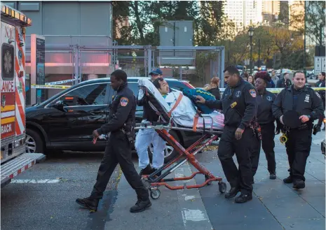  ?? AP PHOTO ?? Emergency personnel carry a man into an ambulance after a motorist drove onto a busy bicycle path near the World Trade Center memorial in New York and struck several people Tuesday.