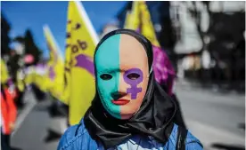  ??  ?? ISTANBUL: A woman wears a mask as she takes part in a march yesterday at Bakirkoy district in Istanbul, ahead of the World women day. — AFP