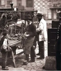  ??  ?? A Victorian locksmith mends locks at his stall in the street, c1877