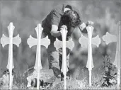  ?? Larry W. Smith EPA/Shuttersto­ck ?? A MOURNER leans over two of the 26 crosses representi­ng the Texas mass shooting victims.