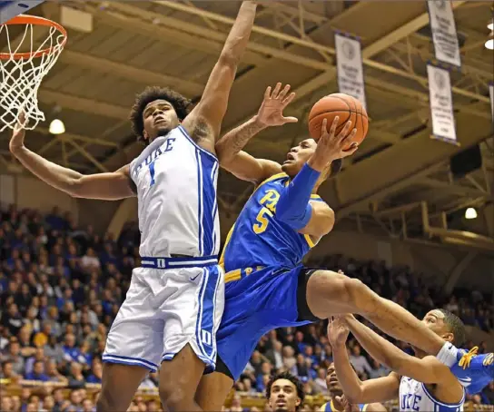  ?? Grant Halverson/Getty Images ?? Au’Diese Toney, right, drives against Duke’s Vernon Carey Tuesday night in Durham, N.C.