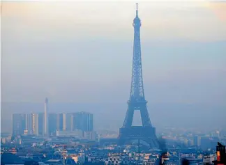  ?? REUTERS ?? The Eiffel Tower is surrounded by a small particle haze as Paris experience­s its worst air pollution in a decade.