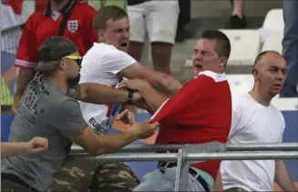  ?? THANASSIS STAVRAKIS, THE ASSOCIATED PRESS ?? Russian supporters attack an England fan at the end of the Euro 2016 Group B soccer match on June 11, 2016.