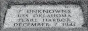  ??  ?? This gravestone identifies the resting place of seven unknown people who died on the USS Oklahoma.