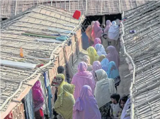  ??  ?? GIRLS ALLOWED: Women walking inside the “widows’ camp” at the Balukhali refugee camp in Bangladesh’s Ukhia district.
