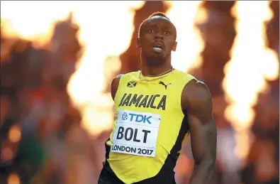  ?? PHIL NOBLE / REUTERS ?? Usain Bolt looks stunned after finishing third in the 100m final at the World Athletics Championsh­ips at London Stadium on Saturday. The Jamaican superstar had been hoping to win his fourth world title in the event to add to his three Olympic 100m...