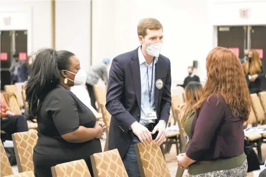  ?? MATT ROURKE/AP PHOTOS ?? U.S. Rep. Conor Lamb, D-Mount Lebanon, one of four Democrats running for U.S. Senate, meets with people during a meeting of the Pennsylvan­ia Democratic State Committee in Harrisburg on Saturday. Lamb got the most votes in what was essentiall­y a straw poll of Democrats from across the state.