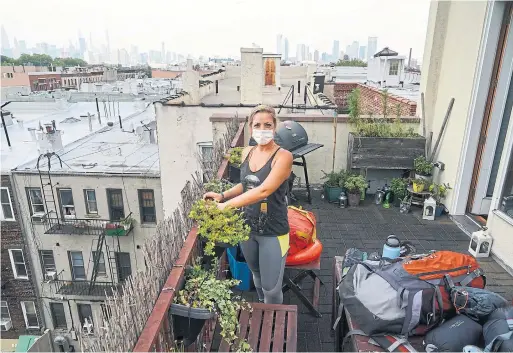  ?? CHANG W. LEE PHOTOS THE NEW YORK TIMES ?? Elena Gaudino, at her Brooklyn home with gear for her vacation, has been keeping her plans quiet to avoid conflict with people who think she shouldn’t travel.