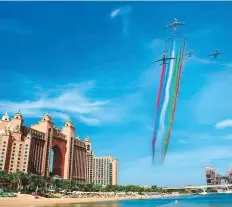 ?? Courtesy: Emirates ?? The spectacula­r formation passes Dubai’s Palm.