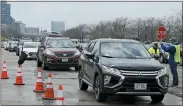  ?? TONY DEJAK — THE ASSOCIATED PRESS ?? Cars line up to receive food at the Greater Cleveland Food Bank food distributi­on, Thursday, May 14, in Cleveland.