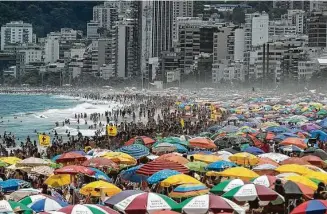  ?? Bruna Prado / Associated Press ?? Despite restrictio­ns to limit the spread of COVID-19, thousands on Sunday crowd Ipanema Beach in Rio de Janeiro. Meanwhile, protests call for Brazilian President Jair Bolsonaro’s ouster.