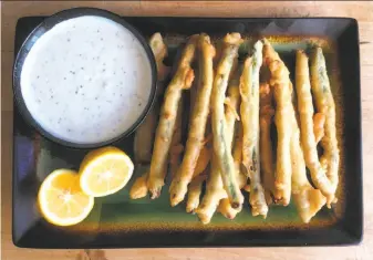  ?? Sarah Fritsche / The Chronicle ?? Fried Asparagus With Meyer Lemon-Mustard Dipping Sauce makes good use of the early crop.