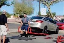  ?? LOANED PHOTOS ?? A CONTESTANT PRACTICES THE CAR DEADLIFT challenge for the upcoming competitio­n.