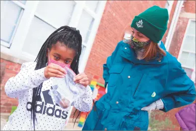  ?? Jarret Liotta / For Hearst Connecticu­t Media ?? Anna St. Louis, 9, shares her project with instructor Meghan Hadley at Tracey Magnet School on Thursday in Norwalk.