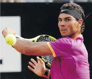  ?? ALESSANDRA TARANTINO/THE ASSOCIATED PRESS ?? Rafael Nadal returns a shot to Dominic Thiem during their quarter-final match at the Italian Open in Rome on Friday. Thiem won the match 6-4, 6-3.