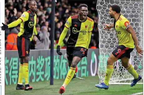  ??  ?? SHOCK AND AWE: Sarr celebrates his opening goal with fellow scorer Deeney (right) in Watford’s surprise victory over Liverpool