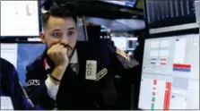  ?? RICHARD DREW — THE ASSOCIATED PRESS ?? Specialist Matthew Grenier works on the floor of the New York Stock Exchange, Tuesday. Stocks are opening sharply lower on Wall Street following big drops in Asia and Europe.