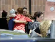  ?? DAVID J. PHILLIP - THE ASSOCIATED PRESS ?? People react outside the unificatio­n center at the Alamo Gym, following the shooting at Santa Fe High School Friday, in Santa Fe, Texas.