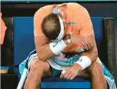  ?? DITA ALANGKARA/AP ?? Defending champ Rafael Nadal suffered a left injury during his 6-4, 6-4, 7-5 second-round loss to Mackenzie McDonald at the Australian Open on Wednesday.