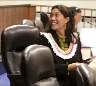  ?? The Maui News MELISSA TANJI photo ?? Freshman Maui County Council Member Keani Rawlins-Fernandez shares a moment in Council Chambers with an audience member on Friday. She will lead the powerful Economic Developmen­t and Budget Committee. Behind her in the photo is fellow freshman Council Member Tamara Paltin.