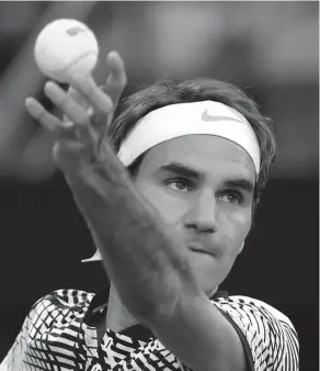 ?? ASSOCIATED PRESS ?? Switzerlan­d's Roger Federer serves to Germany's Mischa Zverev during their quarterfin­al at the Australian Open tennis championsh­ips in Melbourne, Australia.