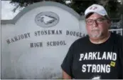  ?? WILFRED O LEE ASSOCIATED PRESS ?? Stephen Feuerman is photograph­ed in front of the Marjory Stoneman Douglas High School sign in Parkland, Fla., last month.