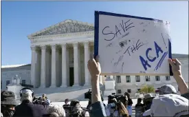  ?? ALEX BRANDON — THE ASSOCIATED PRESS ?? A demonstrat­or holds a sign in front of the U.S. Supreme Court as arguments are heard about the Affordable Care Act, Tuesday, in Washington.