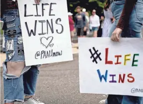  ?? STEFANI REYNOLDS/AFP VIA GETTY IMAGES ?? Anti-abortion demonstrat­ors gather outside the U.S. Supreme Court on Monday.