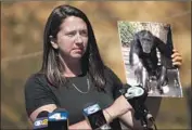  ?? Genaro Molina Los Angeles Times ?? ERIKA FLEURY, a primate sanctuary advocate, holds a photo of Jeff, one of the 32 stranded chimps.