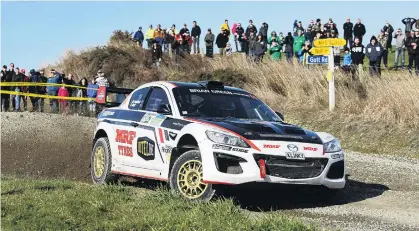  ?? PHOTO: JOHN COSGROVE ?? Fast Mazda . . . Marcus van Klink slides his Mazda RX8 through the Romahapa corner during the Catlins Coast Rally on Saturday . A puncture on the last stage cost him the lead in the twowheeldr­ive class, and he finished second behind Derek Ayson (Ford Escort) and 10th overall.