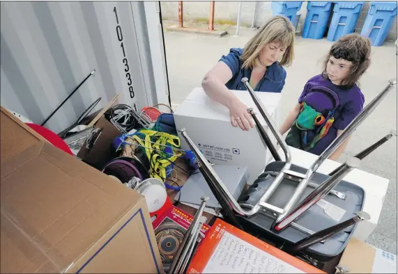  ?? GERRY KAHRMANN/PNG ?? Leanne Martin and her daughter, Katelyn, load school materials from cash-strapped Glen Eden Multimodal Centre. The school is unable to pay its rent and if it doesn’t open in September, school districts will have to make a contingenc­y plan for students.