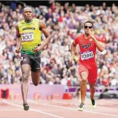  ??  ?? Race goes on Jamaica’s Usain Bolt and United States’ Isiah Young at the Olympic Stadium in London yesterday.
AP