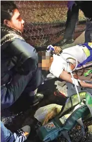  ??  ?? Wounded worshipper­s: Paramedics treat the injured after the early-morning attack