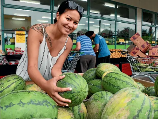  ?? PHOTO: KELLY HODEL / STUFF ?? Local shopper Mereana Cooper, 18, digs for the best watermelon at Dinsdale’s Magic Fresh.