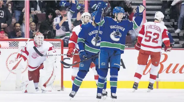  ??  ?? Vancouver Canucks centre Elias Pettersson celebrates his goal on Detroit Red Wings goaltender Jonathan Bernier during the first period of Sunday’s game in Vancouver. Pettersson was returning to the lineup after missing five games with a knee injury. — THE CANADIAN PRESS
