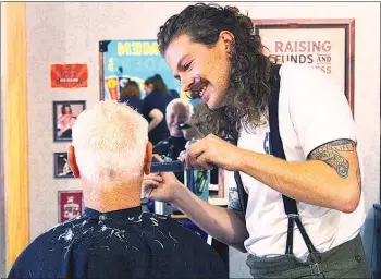  ??  ?? Barter Barber Sam Dowdall cuts the hair of Henry Scheres at Fieldays.