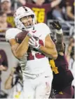  ?? Darryl Webb / Associated Press ?? Stanford’s JJ ArcegaWhit­eside makes one of his 11 touchdown receptions.