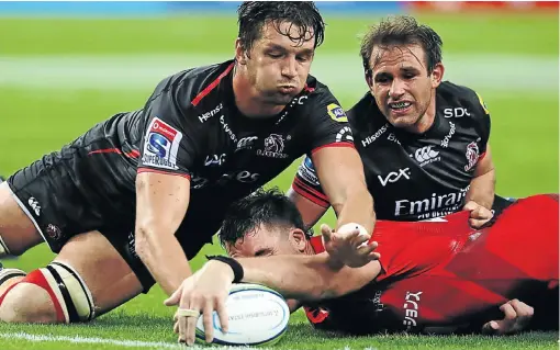  ?? Picture: Getty Images ?? Ruan Vermaak, left, and Nic Groom of the Lions prevent Grant Hattingh of Sunwolves from scoring during yesterday’s Super Rugby encounter in Singapore. The Lions delivered a strong second-half performanc­e to secure a bonus-point win.