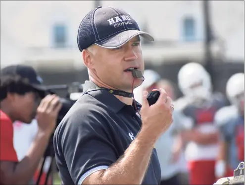  ?? Pete Paguaga / Hearst Connecticu­t Media ?? Hand coach Erik Becker talks to his team during a joint practice between Hand and Greenwich at Strong Field in Madison on Tuesday.