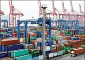  ?? VCG / VIA GETTY IMAGES ?? A truck moves a shipping container last week in Lianyungan­g, China. Beijing has pledged to slap tariffs on U.S. soybeans and other agricultur­al staples as retaliatio­n for U.S. tariff moves.