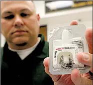  ?? Arkansas Democrat-Gazette/STATON BREIDENTHA­L ?? Maj. Carl Minden of the Pulaski County sheriff’s office displays a Narcan kit Tuesday. Authoritie­s say the nasal spray medication has saved multiple people in Pulaski County from opioid overdoses.