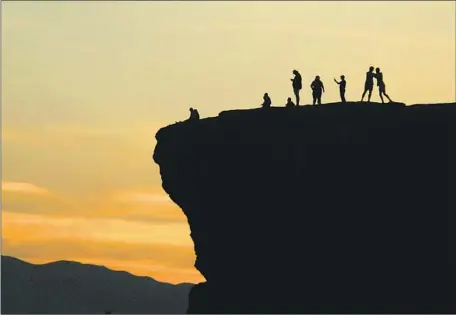  ?? Luis Sinco Los Angeles Times ?? SUNSET WATCHERS in St. George, Utah, where the Virgin River is a major tributary to the Colorado River. A push by Arizona Democrat Kyrsten Sinema added $4 billion to the Senate’s healthcare, climate and tax bill to address the water crisis along the Colorado River.