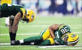  ?? Ezra Shaw Getty Images ?? LaDARIUS GUNTER, left, and Morgan Burnett of the Packers react after colliding during a game against the Cowboys. Burnett is questionab­le for today’s game.