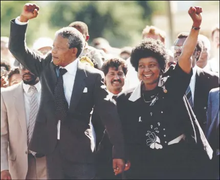  ?? AP PHOTO ?? Nelson Mandela and wife Winnie walk hand in hand, raising their clenched fists upon his release from Victor prison, on Feb. 11, 1990, in Cape Town.