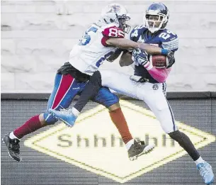  ?? Graham Hughes / THE CANADIAN PRESS ?? Montreal Alouettes’ B.J. Cunningham, left, challenges Toronto
Argonauts’ A.J. Jefferson during CFL action on Monday.