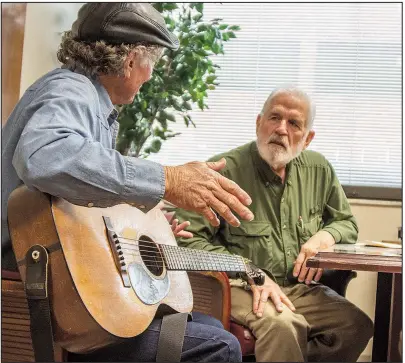  ?? Arkansas Democrat-Gazette/CARY JENKINS ?? Songwriter Wood Newton (left), formerly of Hampton, listens as veteran William Donald “Don” Newton (no relation) of North Little Rock tells about his time in Vietnam during a Feb. 15-16 retreat for the Little Rock Chapter of Operation Song, held at the Eugene J. Towbin Veterans Healthcare Center in North Little Rock. The nonprofit Operation Song, of which Wood Newton is a part, brings Nashville songwriter­s together with veterans, active duty military members and their families to heal through songwritin­g.