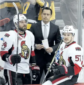  ?? GENE J. PUSKAR/AP ?? Ottawa head coach Guy Boucher, centre, stands behind Viktor Stalberg, left, and Tommy Wingels during the third period of a 7-0 Game 5 loss to the Pittsburgh Penguins on Sunday.